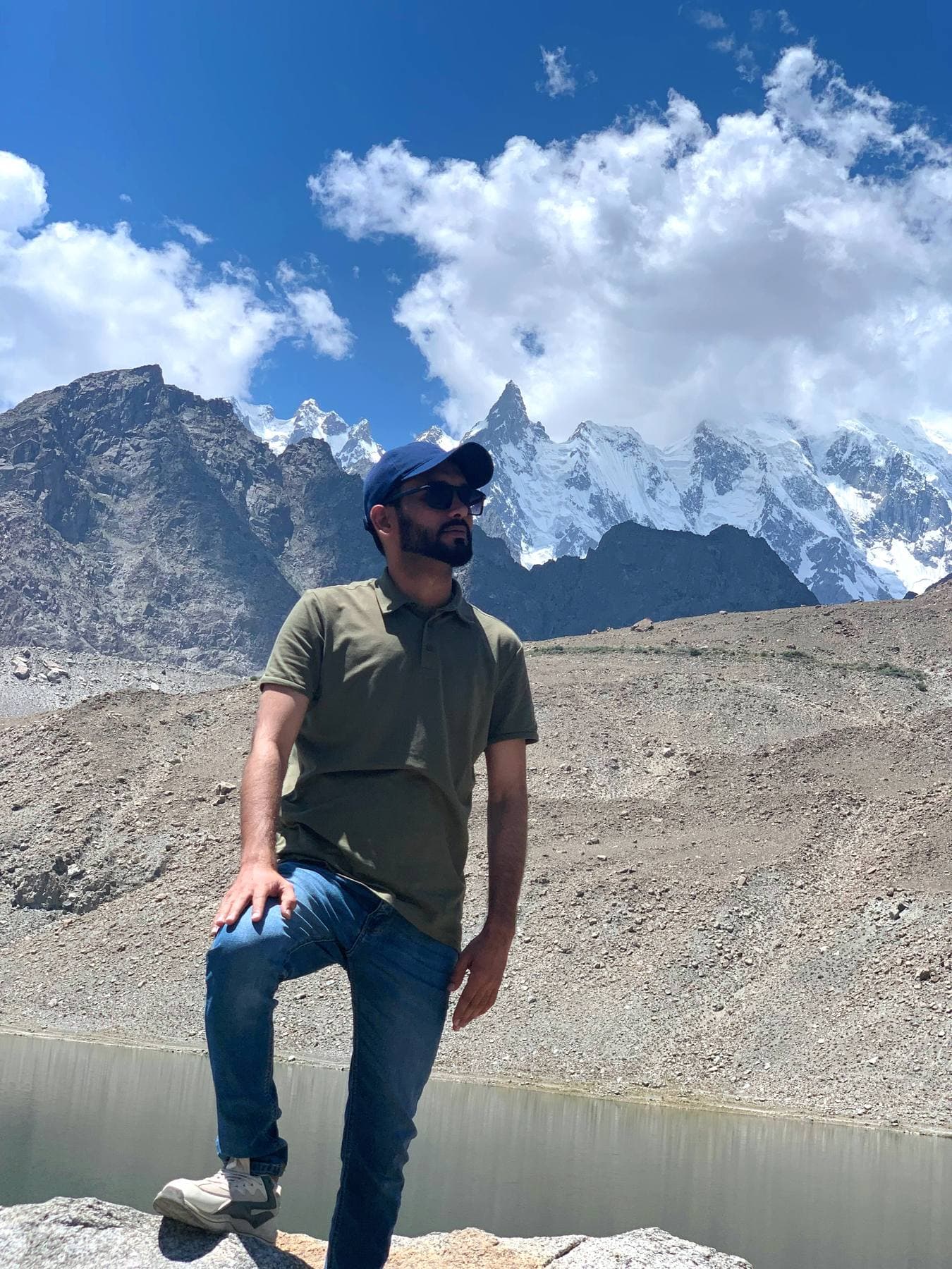 A quiet lakeside stop with the Karakoram peaks lined up behind.